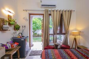 a bedroom with a bed and a sliding glass door at Matrika Homestay in Lucknow