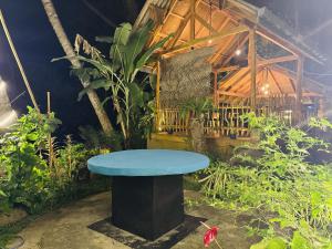 a blue bench in the middle of a garden at Dilaro Rest & Villa in Kottagoda