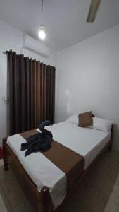 a bedroom with two beds and a window at Stay Suite in Mahiyangana +1 photo