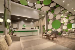 a lobby of a store with green and white at Go Hotels Ortigas Center in Manila