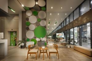 a lobby with chairs and tables in a store at Go Hotels Ortigas Center in Manila