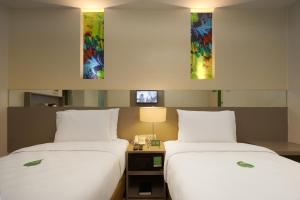 two beds sitting next to each other in a hotel room at Go Hotels Ortigas Center in Manila