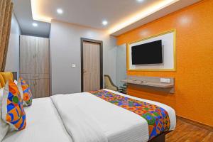 a hotel room with a bed and a tv at FabHotel Disa in kolkata
