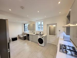 a kitchen with a sink and a dishwasher at Precious House 2 in Leicester