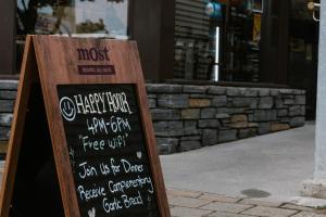a chalkboard sign in front of a store at Clock Tower Accommodation in Hokitika