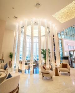a lobby of a hotel with chairs and tables at Kempinski Residences & Suites, Doha in Doha