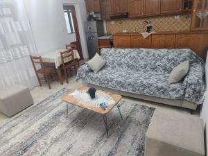 a living room with a couch and a table at Oremari Home in Korçë