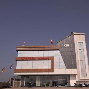 a building with a sign on top of it at Mithila Resort in Jāmb