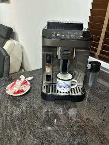 a coffee maker sitting on a counter with a cup at Súkromný apartmán in Senec +3 photos