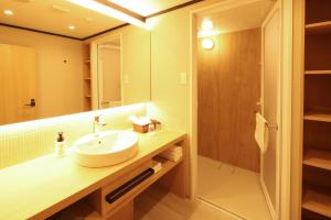 a bathroom with a sink and a mirror at HATAGO HIKONE - Annex in Hikone