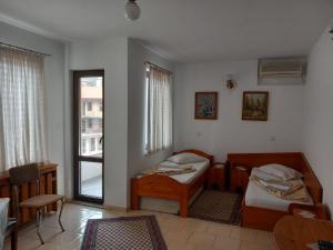 a room with two beds and a window at Hotel Mishel in Kocherinovo