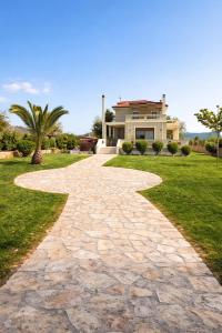 a stone path in front of a house at Villa Anemos in Nafplio