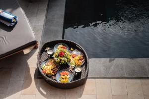 a basket filled with food next to a swimming pool at Villa Mesari Bona in Blahbatu +7 photos