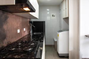 a kitchen with a stove and a counter top at Polanco Residences Tocagua Cartagena - Colombia in Cartagena de Indias +18 photos