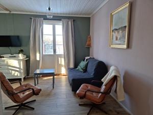 a living room with a couch and two chairs at Cottage Lake view Dalarna - Tolvsbo in Söderbärke +24 photos