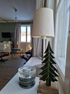 a lamp on a table with a christmas tree on it at Cottage Lake view Dalarna - Tolvsbo in Söderbärke