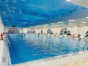 a large swimming pool with a blue ceiling at Prime Hotel in Thái Nguyên