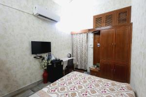 a bedroom with a bed and a television in it at Matrika Rooms in Lucknow