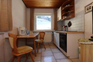 a kitchen with a table and chairs and a window at Doppelzimmer Schwarzwaldharmonie mit gem. Küche in Todtmoos +16 photos
