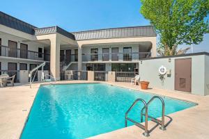 a swimming pool in front of a building at Quality Inn Foley - Gulf Shores North in Foley