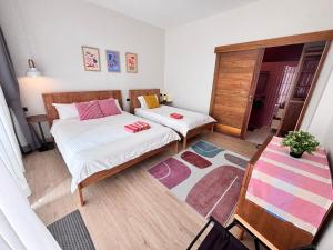 a small bedroom with two beds and a rug at Villanarachaam in Cha Am +35 photos