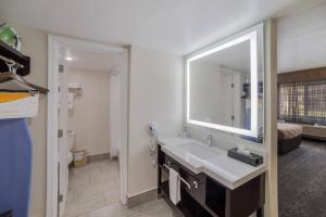 a bathroom with a sink and a mirror at Quality Inn & Suites Goodyear - Phoenix West in Goodyear