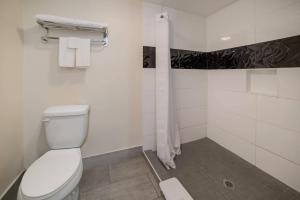 a white bathroom with a toilet and a shower at Quality Inn & Suites Goodyear - Phoenix West in Goodyear +63 photos