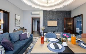 a living room with a couch and a table at Monotel Hotel in Ustʼ-Kamenogorsk +29 photos