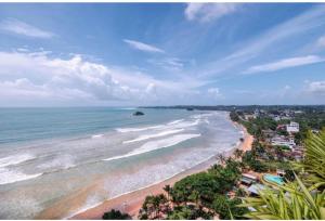 an aerial view of a beach with the ocean at HindaHaven in Weligama