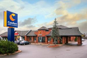 a building with a sign in front of it at Comfort Hotel & Suites in Peterborough