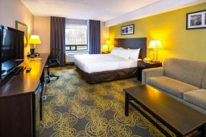 a hotel room with a bed and a television at Comfort Hotel & Suites in Peterborough