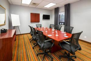 a conference room with a long table and chairs at Comfort Hotel & Suites in Peterborough +24 photos