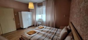 a bedroom with a bed with two towels on it at Sunny Central Apartment in Sofia
