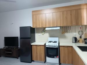 a kitchen with a stove and a refrigerator at Capital Transit Hub in Port Moresby +3 photos