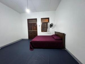 a bedroom with a bed in a room with a window at Aathi Villas in Jaffna