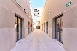 an empty alley between two buildings in a city at Sant Adrià Urban Suites by gaiarooms in Badalona