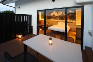 a room with a table and a bed on a balcony at HATAGO HIKONE - Main building in Hikone