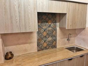 a kitchen with a sink and a counter top at Vasantvasoj Homestay in Pauri +32 photos