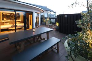a patio with two benches on a balcony at HATAGO HIKONE - Main building in Hikone +4 photos
