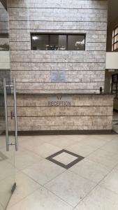 a building with a sign that says reception at Cozy Retreat Near Nairobi National Park, Giraffe Centre & Wilson Airport in Nairobi +10 photos