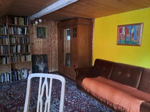 a living room with a couch and a chair at Haus an der Stadtmauer in Lychen