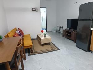 a living room with a couch and a tv at Capital Transit Hub in Port Moresby