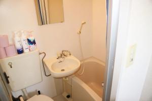 a small bathroom with a sink and a toilet at Joinus Ise Apartment by Tranova in Ise