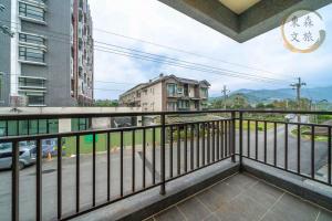a balcony with a view of a street at 遇見礁溪-寵物友善-免費停車-無門禁24小時進出-東森文旅-包棟優惠中 in Jiaoxi