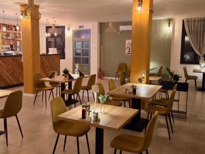 a restaurant with tables and chairs in a room at La Vida Panorama in Batina