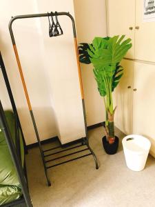 a bathroom with a plant next to a toilet at Joinus Ise Apartment by Tranova in Ise