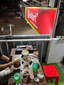 a table with food on it in a food stand at Homestay 14 Tôn Đức Thắng in Phan Thiet