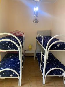 a room with two bunk beds and a lamp at Le Mille e Una Notte II in Olbia