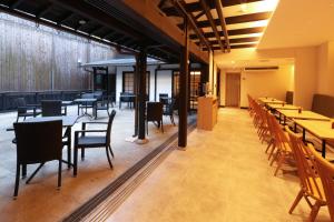 a dining room with tables and chairs and tablesktop at HATAGO HIKONE - Annex in Hikone