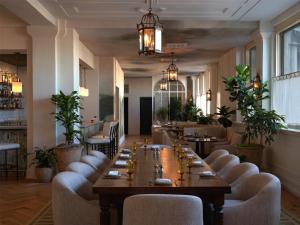 a restaurant with a long table and chairs at The Bellevue Hotel, in the Unbound Collection by Hyatt in Philadelphia